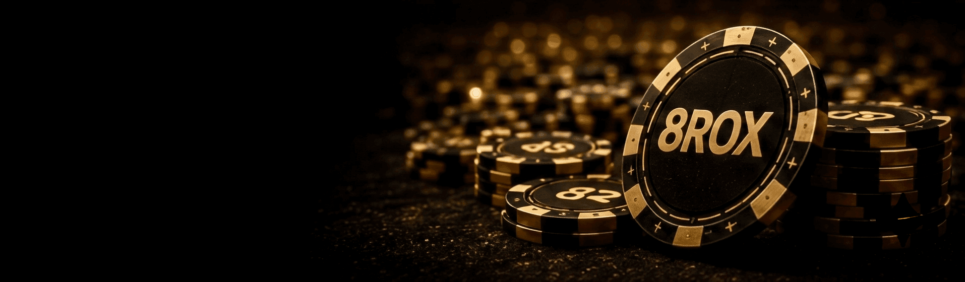 8ROX poker chips stacked on a table under warm golden light